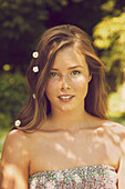 Portrait of Young Woman Outdoors with Flowers in her Hair