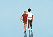 Affectionate boy friends hugging and walking with soccer ball