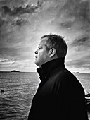 Profile portrait of mid-adult man on sailboat