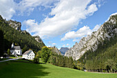 Austria,Styria,ENNSTAL Alps,in the middle of a pine tree forest  and at the bottom of a limestone cliff stands the Johnsbach chapel