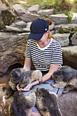 Portrait of a young woman feeding marmots