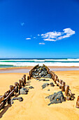 View of wooden pillars and stones on the beach of Seignosse,Landes,France
