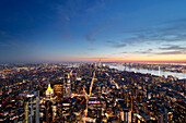 USA. New York City. Manhattan. Empire State Building. View from the top of the building at dusk and night. View of the One World Trade Center and lower town. The Hudson river is visible on the right.