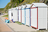 France. Normandy. Department of Manche. Granville during the summer. The dam. The bath cabins. Woman sunbathing hidden in her cabin.