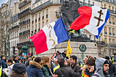 March 2,2019. Paris. Demonstration of the Yellow Vests against the policy of the Macron government. Act 16. Place Denfert-Rochereau. Yellow Vests,Flags and "The Lion of Belfort",the statue of Auguste Bartholdi (1880)