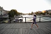 France,Paris,6 th district,woman walking on the Passerelle des Arts.