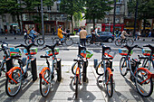 France,Nantes,44,Cours des 50 Otages,cyclists one behind the other,in the foreground: Bicloo station,May 2021.