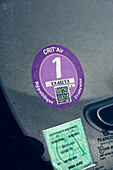 Crit'air sticker and green insurance sticker on a windshield