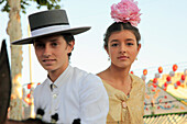 Spain,Andalusia,Seville,festival,couple on horseback