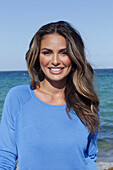 Woman in blue jumper on the beach