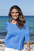 Woman in blue jumper on the beach