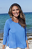 Woman in blue jumper on the beach