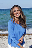 Woman in blue jumper on the beach