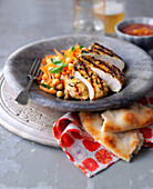 Grilled chicken with chickpea salad and naan bread