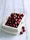 Fresh cherries in a wooden basket