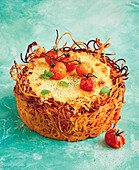 Spaghetti cake with cherry tomatoes and herbs