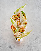 Caesar salad with grilled chicken and poached egg