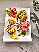 Milk-fed lamb chops with garlic fritters and basil jus