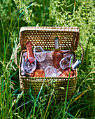 Picnic basket with rosé wine and glasses