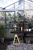 Rustic table decoration with flower arrangement in greenhouse
