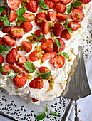 Meringue tart with strawberries and whipped cream