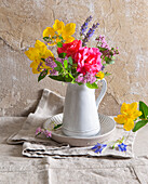 Bouquet of summer flowers in a white ceramic vase