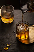 Whisky in a tumbler with ice cubes