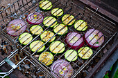 Courgettes and onions in a grid on the grill