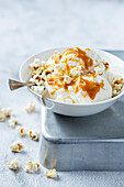 Vanilla ice cream with caramel sauce and popcorn