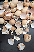 Broken eggshells on a grey background