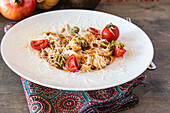 Pasta with pesto, cherry tomatoes and parmesan