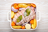 Porchetta (rolled pork roast) with vegetables and potatoes