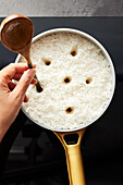 Poking holes in rice (Persian cuisine)