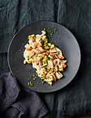 Pasta salad with roast meat, peppers and chives