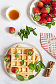 Waffles with strawberries and mint