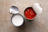 Open cans of coconut milk and peeled tomatoes