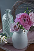 Ranunculus and camomile in a white vase