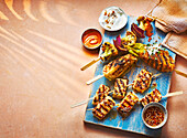 Grilled halloumi and cauliflower skewers with honey-sesame glaze and spicy dipping sauce