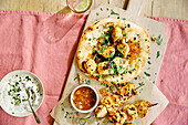 Chicken tikka on naan with yoghurt dip and mango chutney