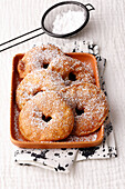 Apple rings in a dressing gown with icing sugar