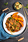 Asian noodles with tempeh and baked pumpkin, cucumber salad