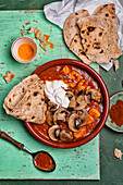 Chicken curry with mushrooms and yoghurt, served with naan bread