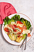 Roasted romaine lettuce with lemon dip and strips of ham