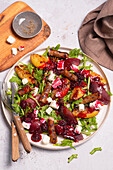 Rocket salad with feta, plum sauce and sausages