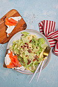 Iceberg lettuce with lemon dressing served with bread with smoked salmon and cream cheese