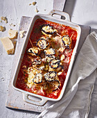 Baked aubergine rolls in tomato sauce