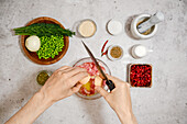 Preparing meatballs with peas and cranberry sauce