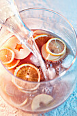 Non-alcoholic lemon and apple cocktail is topped up with water