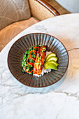 Teriyaki salmon on rice with spinach and avocado