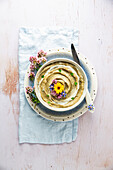 Aubergine dip with edible flowers